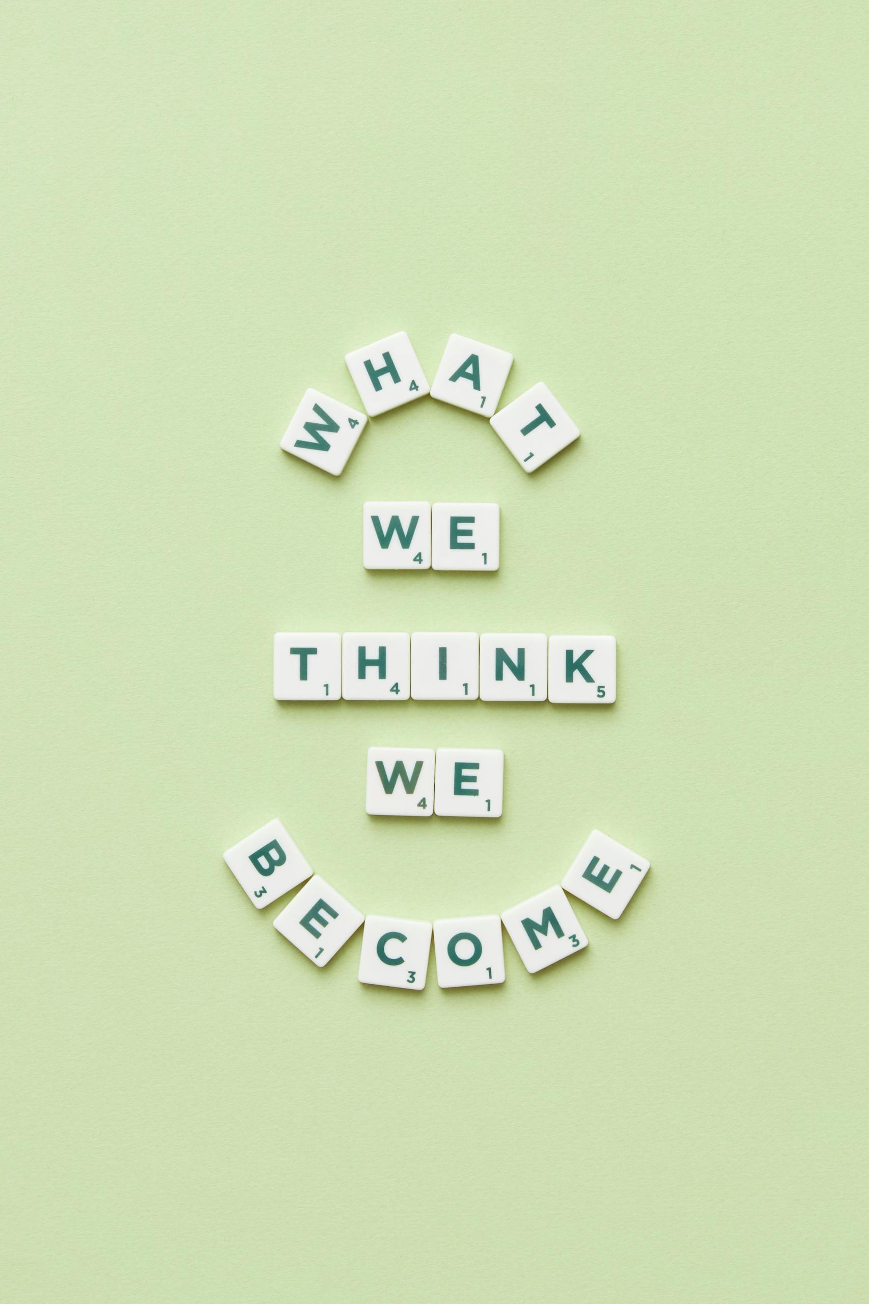 Motivational quote arranged with letter tiles on a light green background.